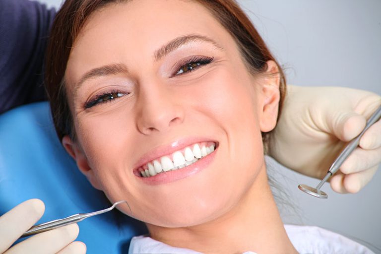 Dentist Performing Cosmetic Dentistry Procedure on a Women in Weyburn, Sk