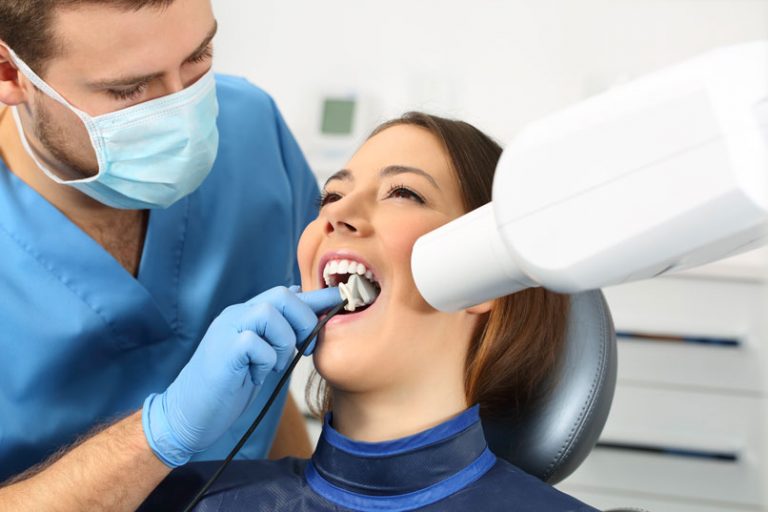 Dentist Performing Emergency Dental Care Procedure In Weyburn, SK