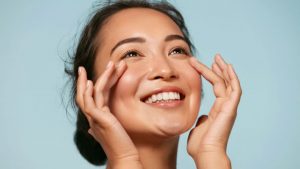 Smiling Woman Gently Touches Her Face